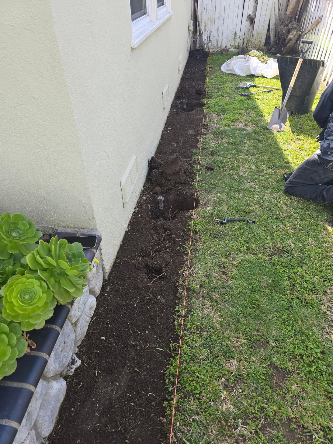 Side-yard rock bed — before